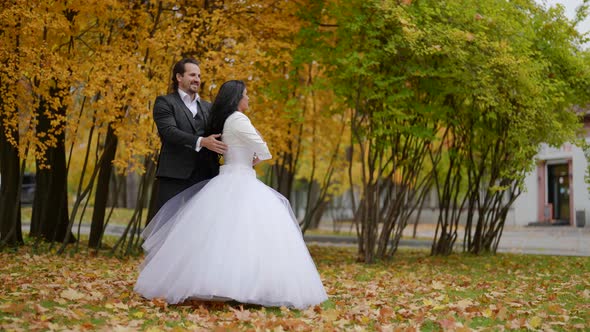 Groom and Bride are Rehearsing Their Celebratory Dance for Wedding Day in Park alt