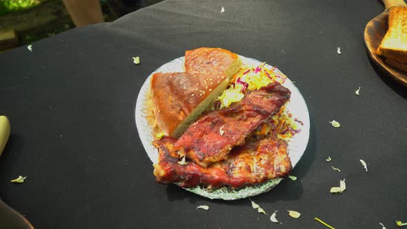 Enjoying the view of grilled ribs on disposable plate. Grilled meat. Plate of grilled ribs alt