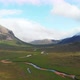 Aerial Drone View Over Winding River Revealing Mountain Valley in Isle of Skye - VideoHive Item for Sale