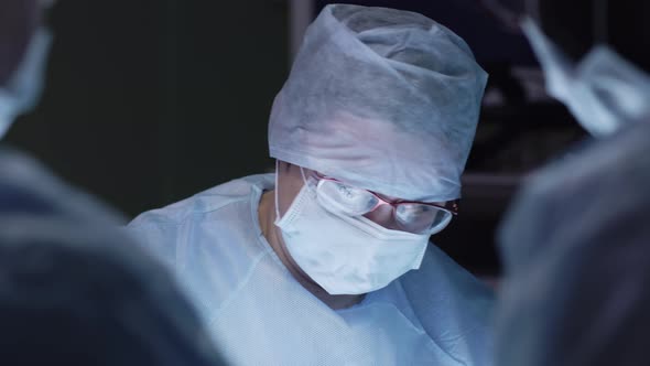 Female doctor looking down at operating table