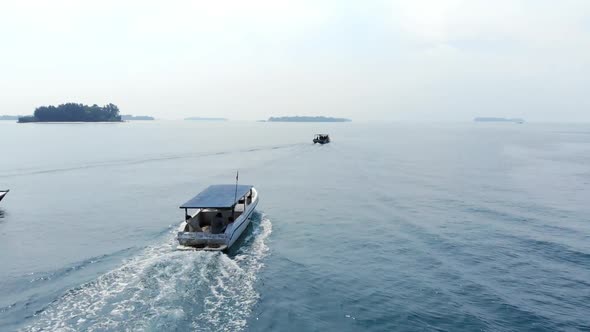 Aerial view of boat with tourists cruising in the ocean