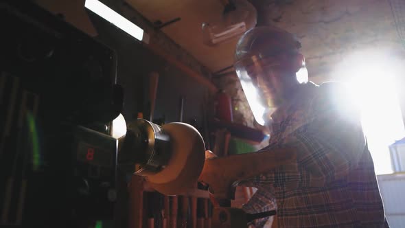 The Owner of a Small Woodworking Business Works in His Workshop on an Order for the Manufacture of alt