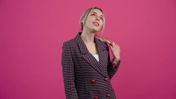 Shy Young Woman Looking Up Thinking with Her Hands in the Middle Hugging alt