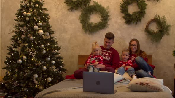 Happy Family Watching Movie Together at Christmas