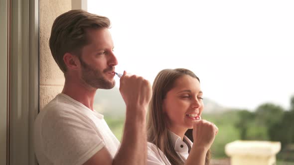 Couple Brushing Teeth Together
