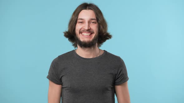 Portrait of Glad Optimistic Guy Wearing Gray Tshirt Expressing Happiness While Rejoicing and alt