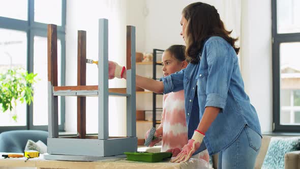 Mother and Daughter Painting Old Table at Home alt