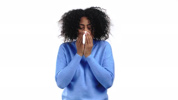 African Woman Sneezes Into Tissue alt