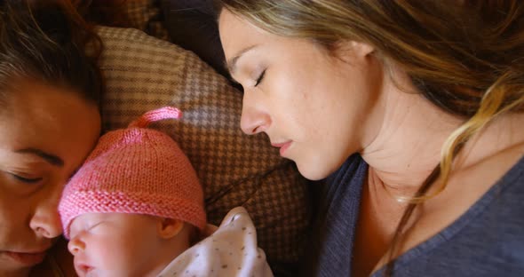 Lesbian couple sleeping with their baby boy at home 4k alt