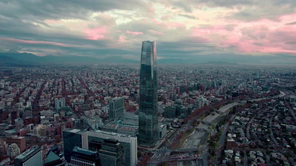 Dolly in aerial view of the financial center of Santiago, Chile. Orange cloudy sunset in the backgro alt