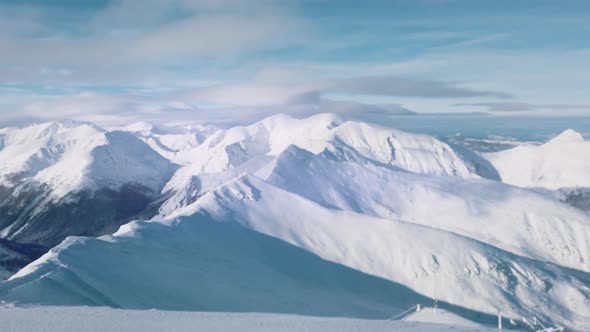 Snowy Mountains In The Winter Landscape With Cloudy Blue Sky During The Day Time alt