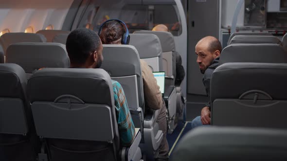Group of Diverse Tourists Boarding for Airplane Flight alt