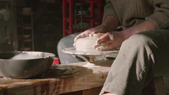 Woman Is Modeling Vessel of Wet Clay alt