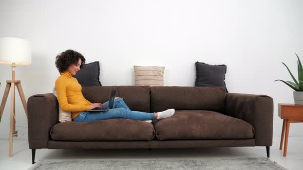 Smiling Hispanic Curly Woman Student Study Uses Laptop Distance Education alt