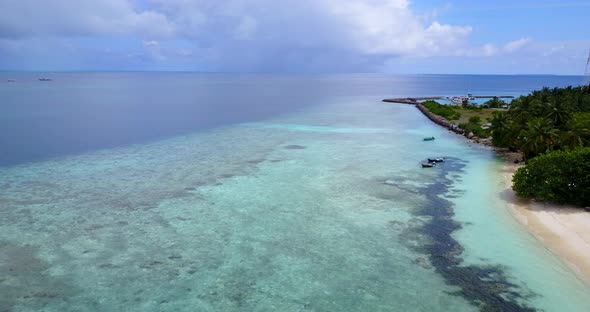 Peaceful shallow lagoon of tropical island with rocky seabed and algae patterns under calm clear wat alt