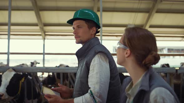 Livestock Owners Walking Shed Together Closeup alt