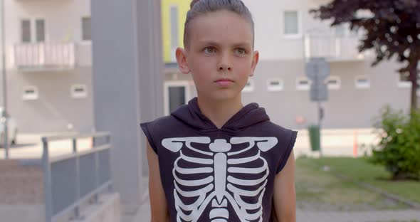 A Teenager Raises and Lowers Dumbbells in His Hands in Courtyard House alt