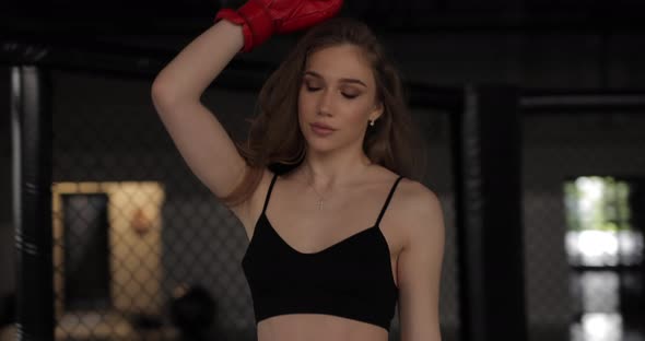 Sexy Boxer Woman in the Boxing Gloves on MMA Ring alt