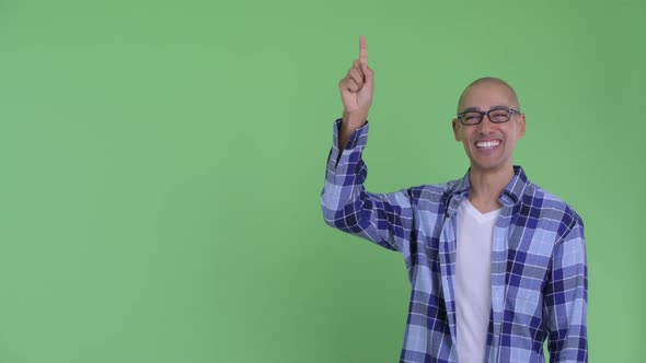 Happy Bald Hipster Man Talking While Pointing Up alt