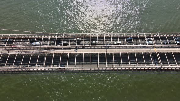 Aerial Flight Over Brooklyn Bridge with American Flag Waving View Over East River New York City U alt