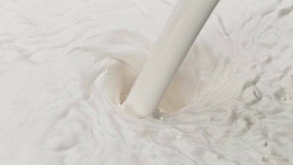 Super Slow Motion Shot of Fresh Milk Pouring Into Whirl at 1000 Fps alt