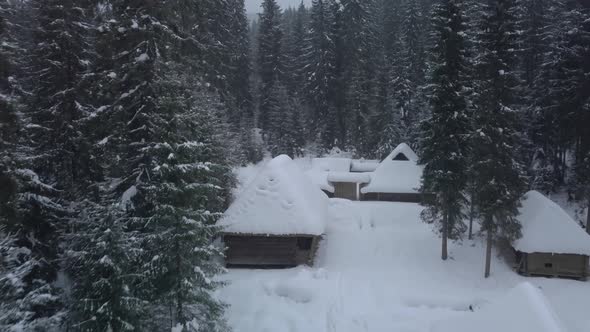 Flying Over Wooden Houses in Winter alt