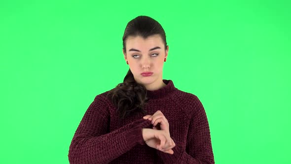 Young Woman Stands Waiting with Boredom on Green Screen. alt