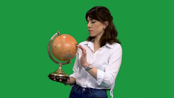 Woman Studying a World Globe