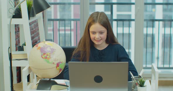 Kid Using Laptop Studying Child Learning Writing at Home Schoolgirl in Coronavirus Pandemic alt