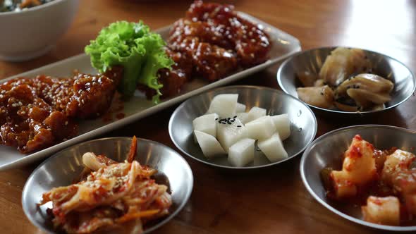 Eating Korean spicy sauce fried chicken with side dishes 4k