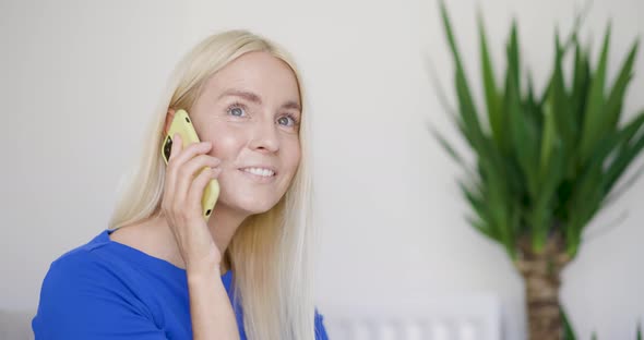 Blond woman talking on the phone