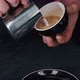 Barista pouring milk in hot coffee and making cappuccino foam in cafe close up, vertical - VideoHive Item for Sale