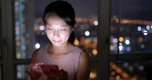 Woman working on cellphone at night  alt