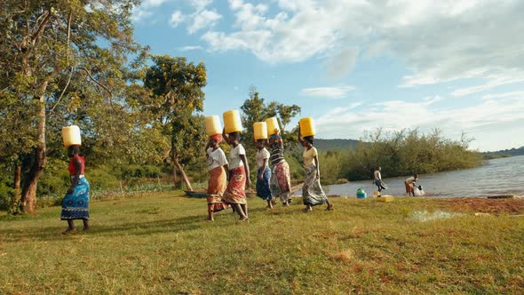 African Women Transporting Water Bottles alt