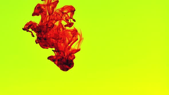 Red Ink Flows Down to Water in Yellow Background