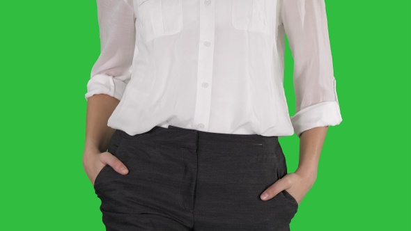 Relaxed Business Woman with Walking with Hands in Her Pockets alt
