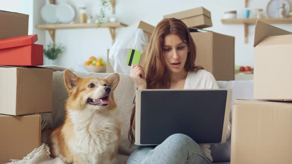 A Woman Uses a Laptop For Online Shopping at Home. Purchase Confirmation By the Internet. alt