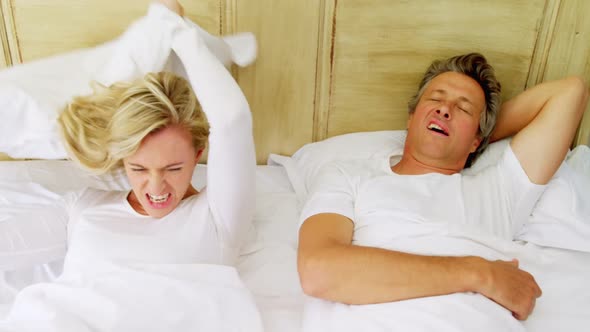 Woman getting irritated while man snoring on bed 4k alt