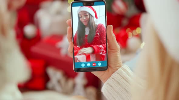 Happy Senior Grandparents Greeting Grandchild Open Christmas Gift on Video Call alt