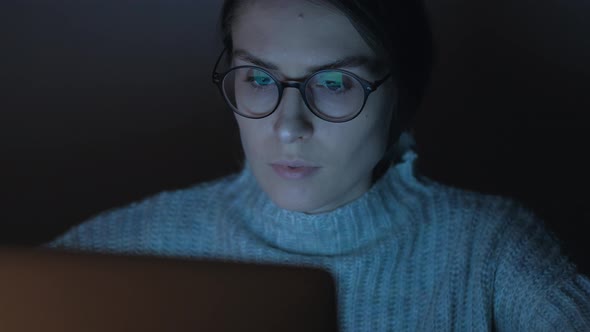 Portrait of a Female Working at the Computer at Night alt