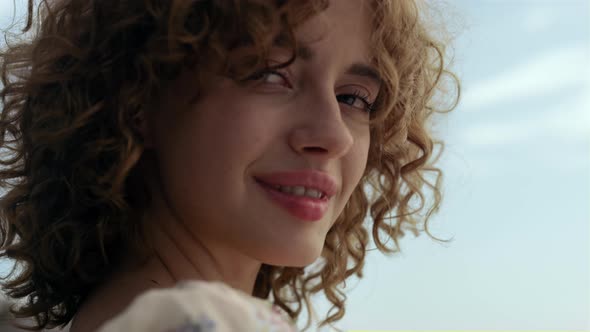 Cute Smiling Woman Face in Front Blue Sky Close Up alt