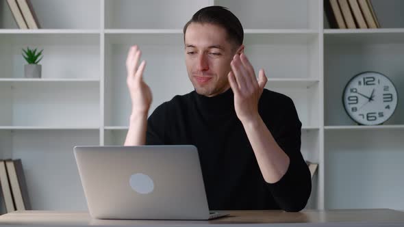 Smiling Businessman Using Laptop Computer for Video Conference While Sitting at Modern Office alt