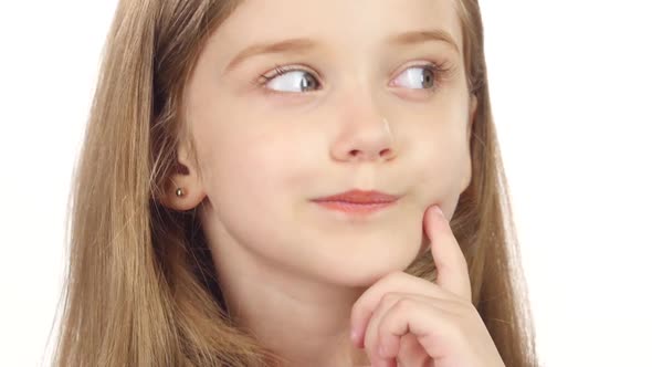 Baby Is Looking at the Side, She Is Thoughtful. White Background. Close Up alt