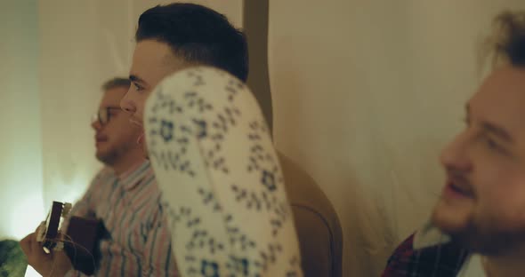 Young Guy Emotionally Sings a Song Among Friends alt