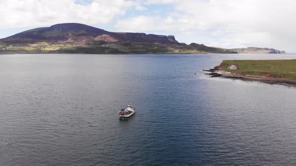 Fishing Boat Moored In Staffin Bay, Isle Of Skye North, The Quiraing Mountain Range Aerial 4K