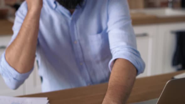 Tracking video of man using headphones during working at home. Shot with RED helium camera in 8K. alt