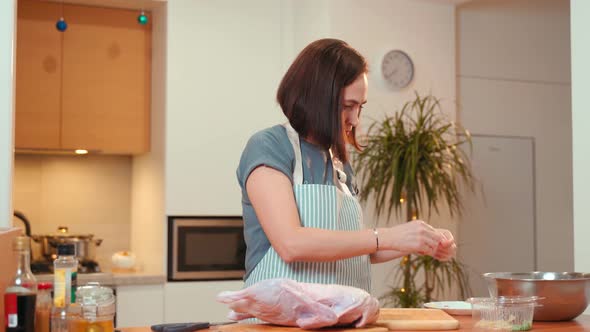 A Woman in the Kitchen Butchers a Duck Removes the Remnants of Feathers alt