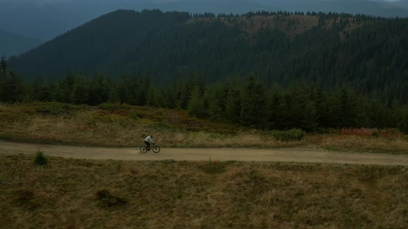 Aerial Mountain Cycling Man Having Fun Hilly Road Against Rocky Green Pikes alt