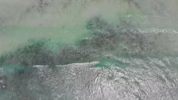 Top Down Aerial View on Blue Turquoise Ocean Breaking Surf Waves in Clear Water alt