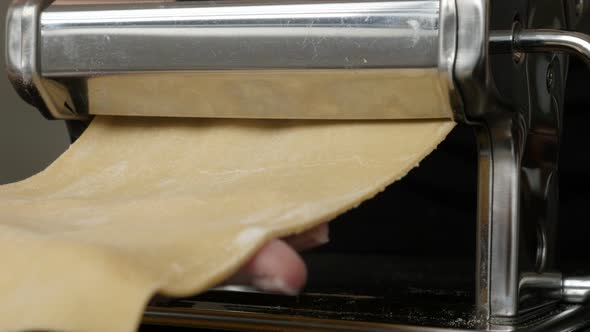 Using kitchen helper machine for making pasta 4K 2160p 30fps UltraHD footage - Close-up of dough pro